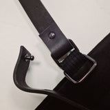 Close-up of detachable faux leather strap with screw button and metal ring attachment