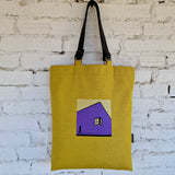 Handmade yellow canvas tote bag with leather handles and purple geometric house embroidery