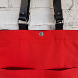 Interior view showing bright red lining, magnetic snap closure, and inner pocket detail