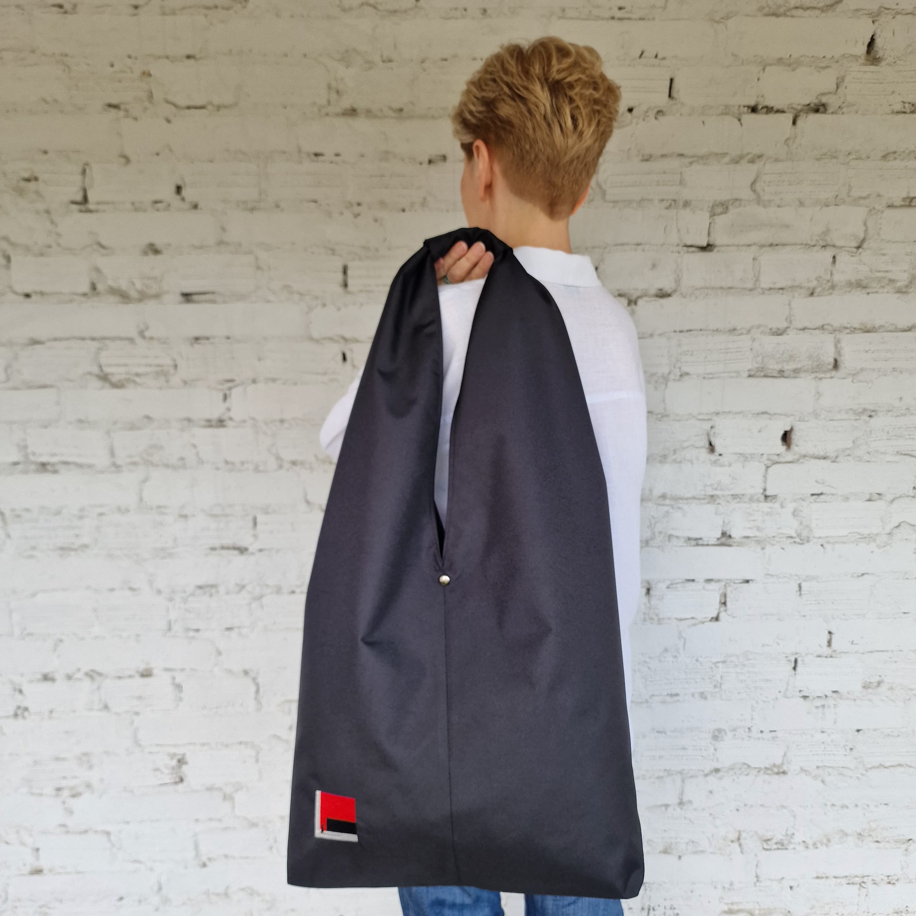 Composite image: Model holding the bag, with close-ups of handle and embroidery details