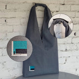 Close-up composite image showing embroidery detail and handle snap closure on grey linen hobo bag
