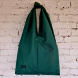 Minimalist silhouette of the bag when not worn. Waterproof fabric keeps contents safe in any weather.