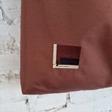 Rust brown hobo bag with geometric embroidered detail on the bottom corner, handmade minimalist tote.