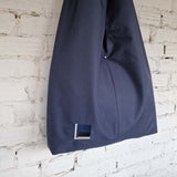 Bottom embroidered corner of navy hobo bag, handmade minimalist waterproof tote detail