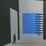 Doormat with geometric design featuring a blue square and black lines on a gray background
