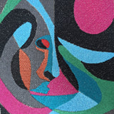 Close-up of a colorful abstract pattern with geometric shapes and vibrant colors.