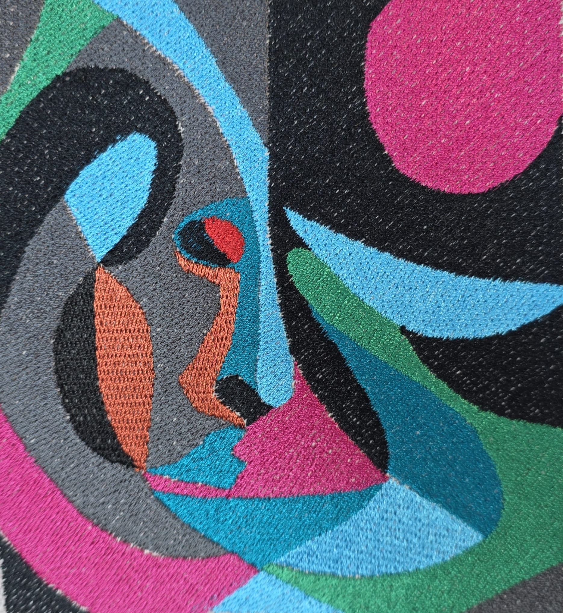 Close-up of a colorful abstract pattern with geometric shapes and vibrant colors.