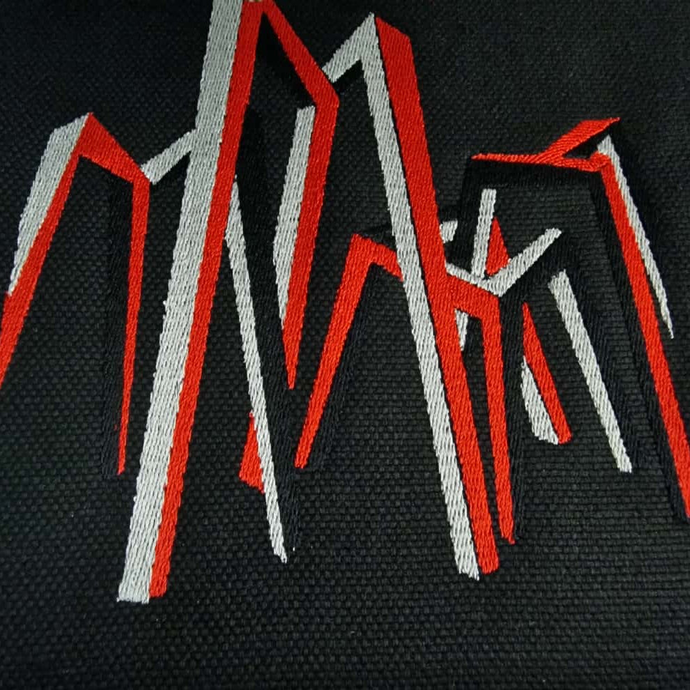 Geometric embroidery inspired by Kazys Varnelis “Chairs,” representing Lithuanian modern art on textile.