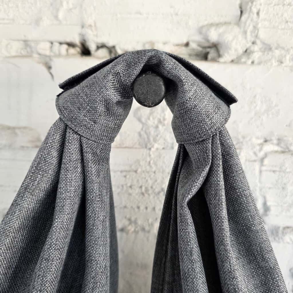 Close-up of knotted handle on gray hobo bag showing durable waterproof fabric texture