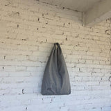 Large gray waterproof hobo bag hanging on wall, minimalist handmade tote