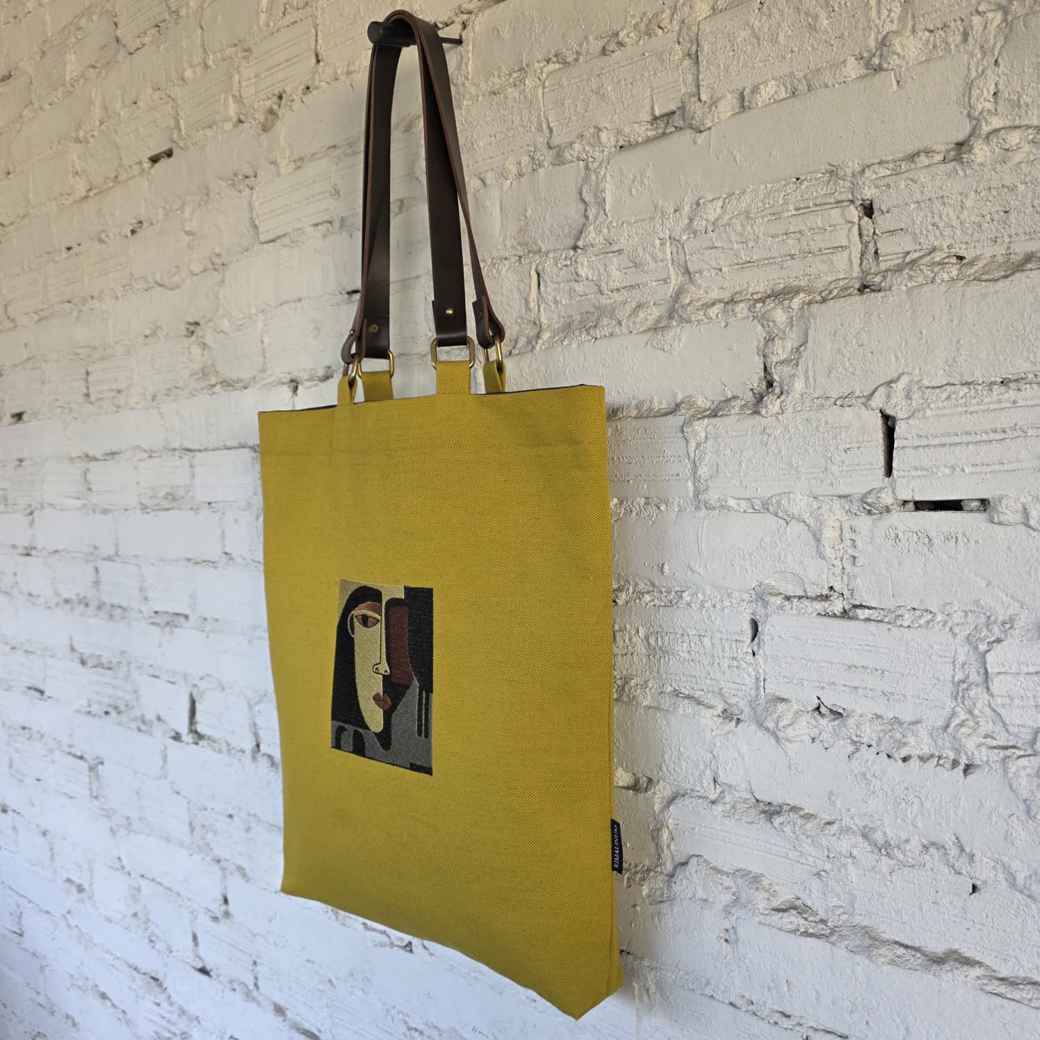 Mustard canvas tote with embroidered abstract face