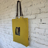 Mustard canvas tote with embroidered abstract face