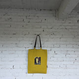 Full view of mustard tote with detachable leather handles