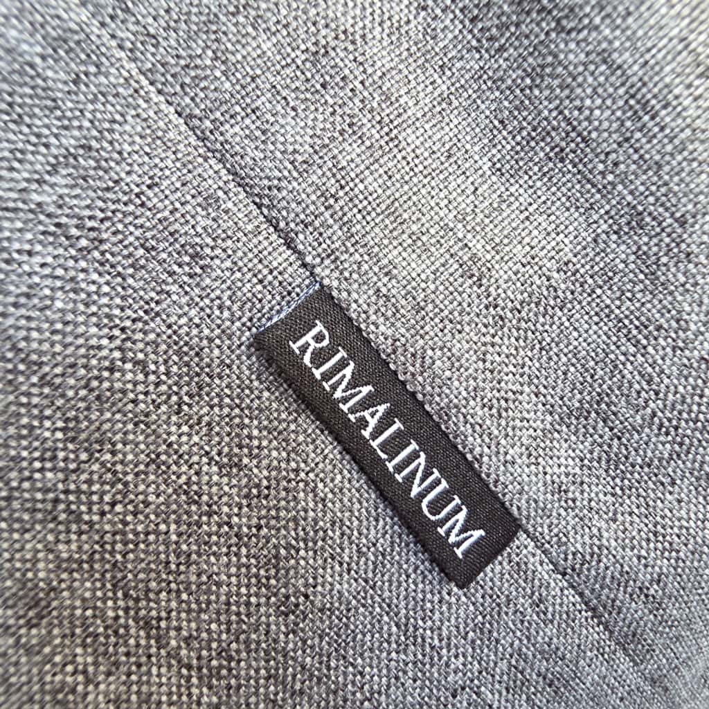RIMALINUM brand label on gray hobo bag, close-up of waterproof fabric detail