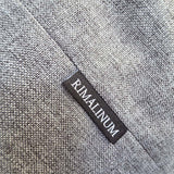 RIMALINUM brand label on gray hobo bag, close-up of waterproof fabric detail