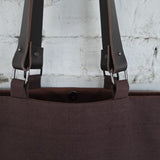 Interior view of brown canvas tote bag with snap closure and durable stitching