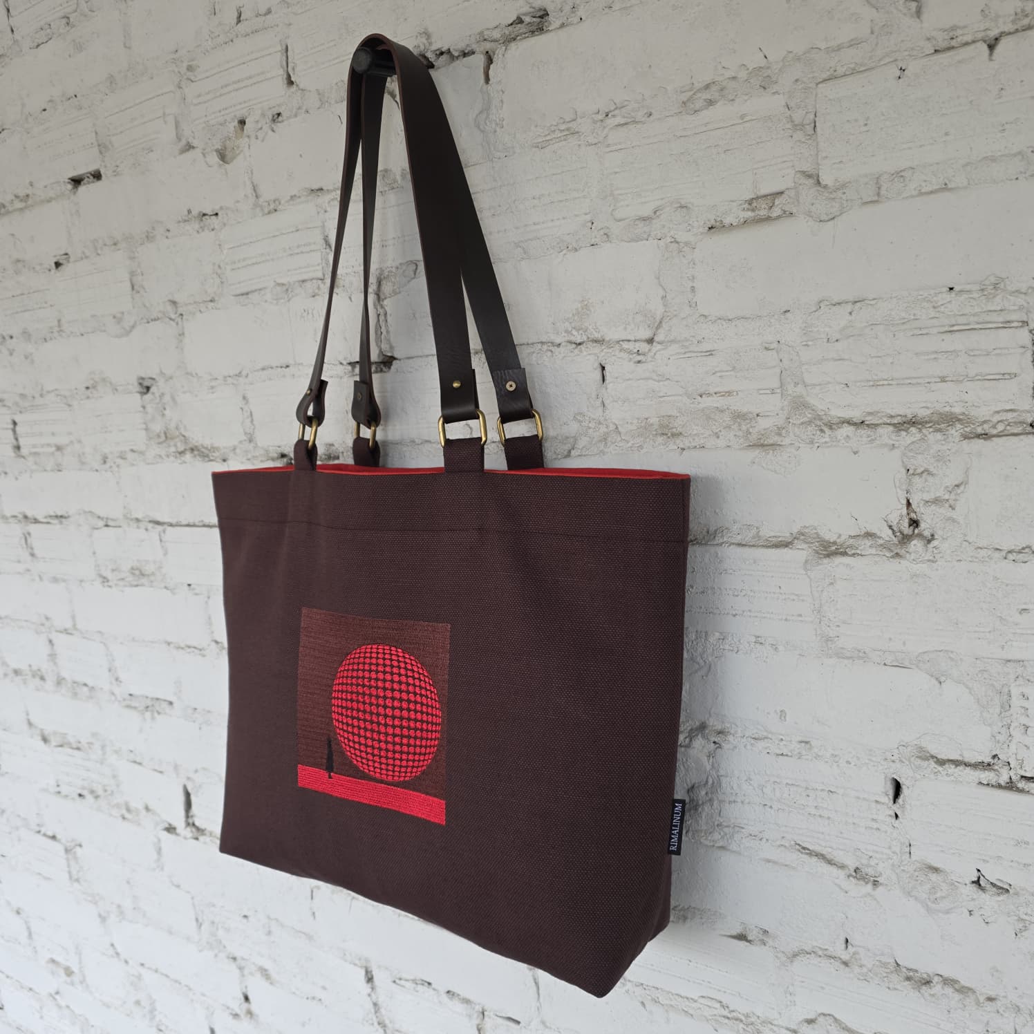 Side view of brown linen tote bag with structured form and leather straps