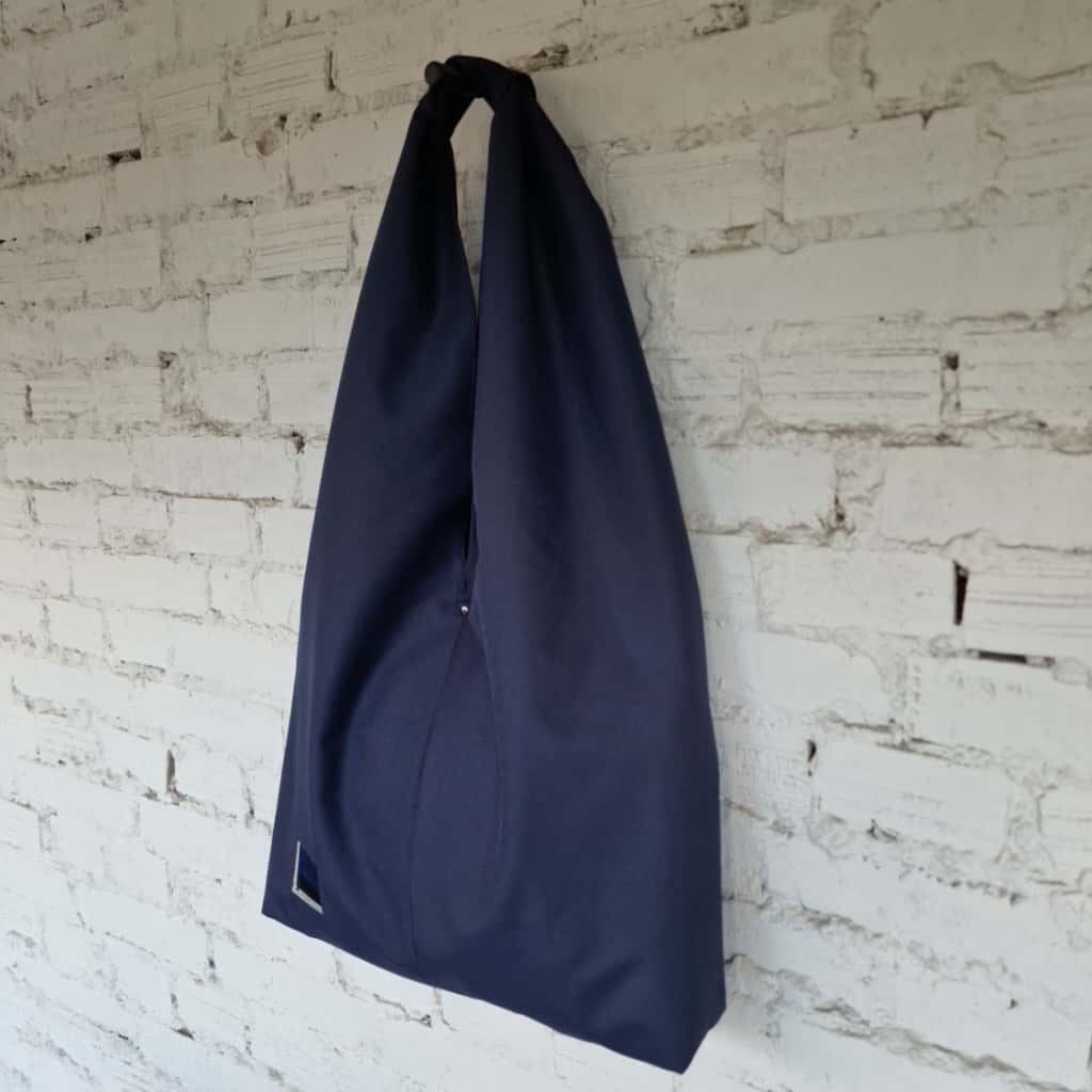 Side view of handmade navy hobo bag, eco-friendly fabric, simple waterproof shoulder tote