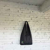Black HOBO bag hanging display — slow fashion accessory handmade with precision.