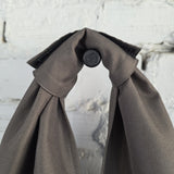 Close-up of wide integrated fabric handle on khaki hobo bag