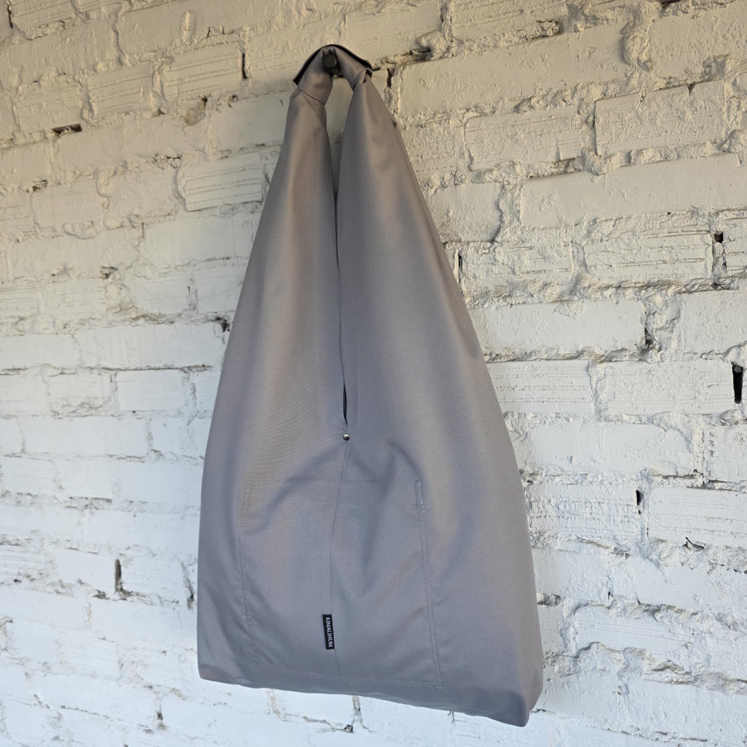 Oversized waterproof hobo tote on wall – handmade unisex minimalist bag