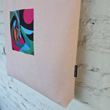 Detailed view of embroidered artwork on handmade pink tote bag fabric