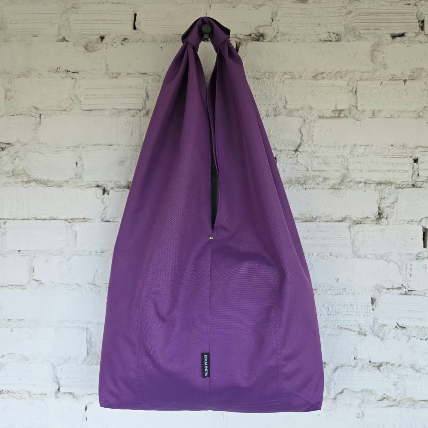 Back view of the purple Hobo bag. The RIMALINUM logo and pocket seams are visible.
