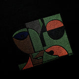 Embroidered abstract design with green, brown, and black colors on a dark background